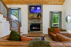[living room] open concept with 55" smart TV and fireplace and large couches
