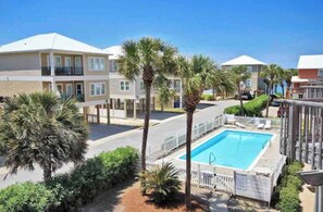 Beachfront homes with ocean views, palm trees, and private pool access.