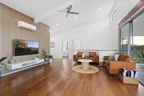 Main living room with smart TV that connects with the balcony.