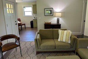 Living room with dining area and kitchen close by