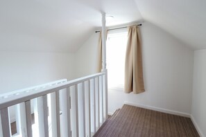 Stairs to attic.  Small heater/airconditioner attached to window. 