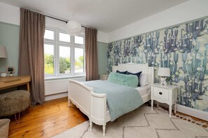Cozy bedroom featuring charming decor and comfortable furnishings, offering a relaxing retreat with its inviting ambiance.