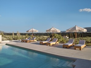 Featuring Premium Sun beds & Umbrellas, pool side.