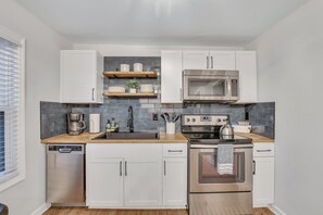 Our updated kitchen with butcher block tops and tile backsplash is stocked with everything that you'll need.