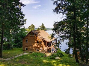 Lakeside House Exterior**: "Charming lakeside house with breathtaking views, perfect for a peaceful retreat amidst nature.