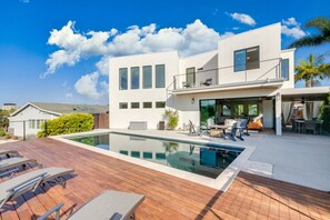Relax and soak up the sun by the pristine pool in this stunning modern retreat. Perfect for a refreshing swim or lounging with friends and family.