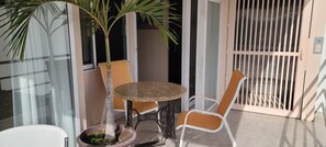table at terrace , entrance to the apartment and , elevator door right side