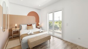 Bright bedroom with a comfortable double bed and balcony access. #LovelyStay #Bedroom