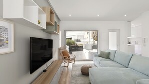 Modern living room with a comfortable sofa in front of a flat screen TV. #TV #Stylish