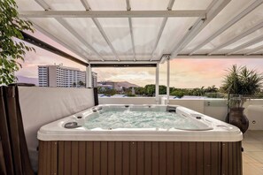 Unwind in the private hot tub while gazing at the scenery.