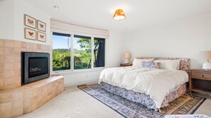 Master bedroom with stunning views and grand fireplace
