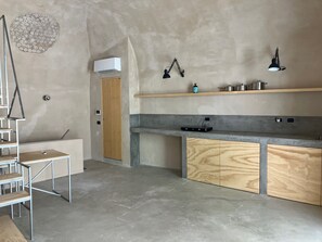 The Kitchen Space made by Concrete inside the Living Room