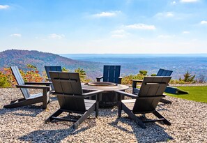Sit back, relax, and take in the stunning mountain views from these cozy fire pit seats.