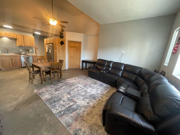 Large open living and kitchen area with vaulted ceilings. 