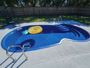 Pool has Ladder and Stairs with Sitting Bench