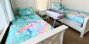 Let your little ones sleep like royalty in this charming princess-themed room with twin beds and a TV.