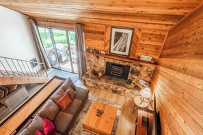 Living room, wood burning fireplace, flatscreen TV, shuffleboard