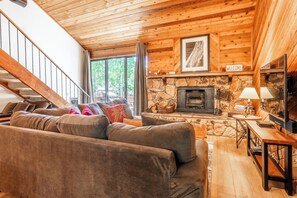 Living room, wood burning fireplace, flatscreen TV, shuffleboard