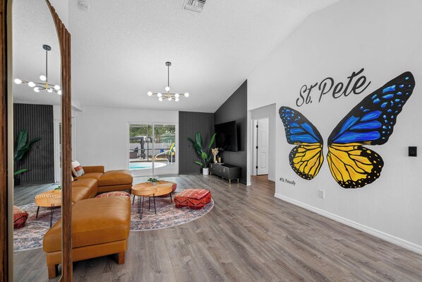 Spacious living room for your group with butterfly wings mural