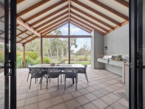 The patio is a shaded entertaining area with a built-in BBQ, dining setting, and uninterrupted views of the golf course.