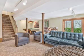 Walk-out basement hangout area with pool table