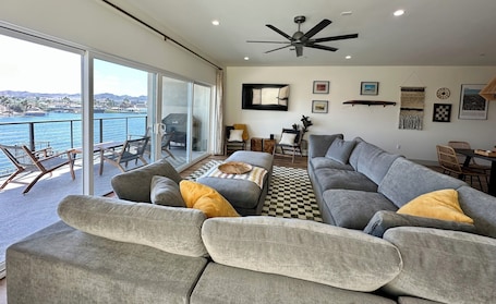2nd story. Living room with 16 foot sliding glass door to balcony and view
