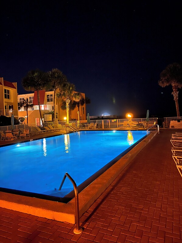 Condo Pool, heated in cooler weather, lit beautifully in the evening time.