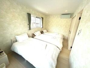 This bedroom can accommodate 3 people. The light green wallpaper gives the impression of being in a forest.