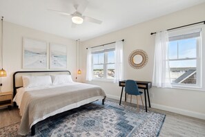 Master bedroom with king bed, Roku smart TV, desk, and ensuite bathroom