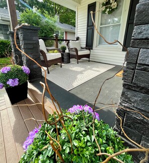 Charming front porch invites you to relax and unwind
