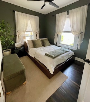 Queen bed frame, smart tv, ceiling fan, comfortable bedding!