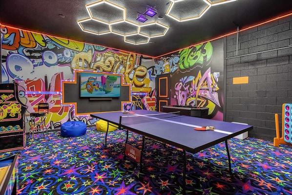Garage-turned-games-room featuring table tennis, arcade games, air hockey and more!