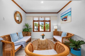 Step into modern elegance with our open design living area, featuring a plush, comfy sofa and unique interior touches that create a stylish and welcoming atmosphere