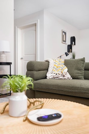 Spacious and inviting, this living room blends modern comfort with urban charm. Perfect for a cozy night in!