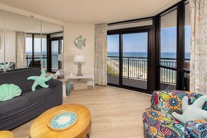 Spacious and bright living room with access to the oceanfront balcony.