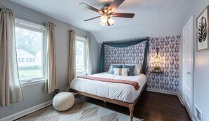 Bedroom with plush king bed, ceiling fan, and cozy ambience. Stretch out, unwind