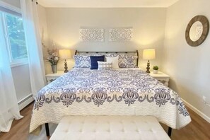 The primary bedroom has a new king bed & bedding, a smart TV & blackout blinds.