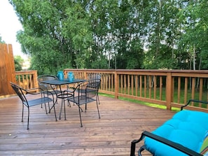 The south-facing deck and backyard have birch trees and lilacs & a grassy yard.