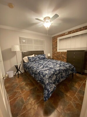 Queen bed in room 1 w/ dresser, closet, and ceiling fan