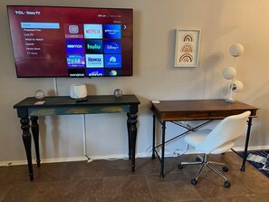 Living room has 55" flat screen smart TV with Roku