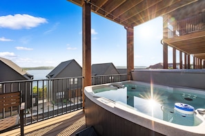 Lower Level: Patio w/ hot tub, fire table, and lake views