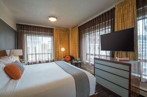 Relax in comfort: Cozy king bed with luxurious linens and ambient lighting in our superior room.