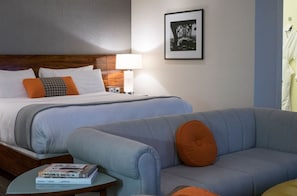 Junior Suite with a king bed and a cozy sofa bed, offering versatile sleeping arrangements in a stylish setting.