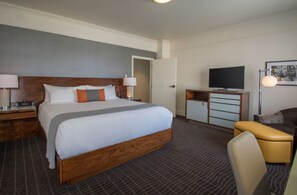 Spacious Gallery Suite with a comfortable bed and separate seating area, perfect for relaxation or work.