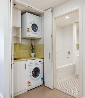 Laundry, including washing machine and dryer available for use