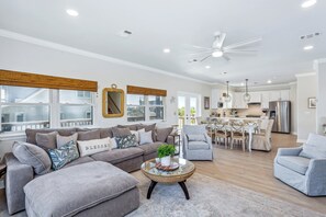 Bright and airy open concept living, dining, and kitchen.