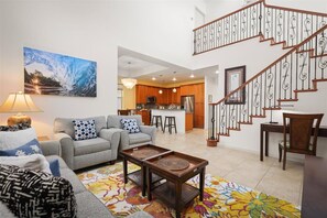Living room with vaulted ceiling and kitchen