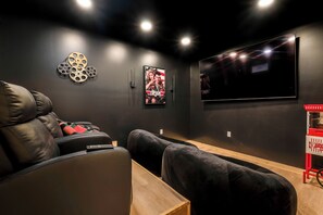 Unwind with family and friends in the cozy private theater, equipped with three reclining chairs and two oversized bean bags for ultimate comfort. Watch your favorite movies or enjoy a game on the impressive 85-inch smart TV.
