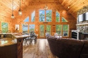 With soaring ceilings and large windows, this cabin invites plenty of natural light and views of the surrounding landscape.  The cabin interiors provide warm and comfort, making it an ideal retreat for nature loves and those seeking a beautiful retreat in the heart of Massanutten.