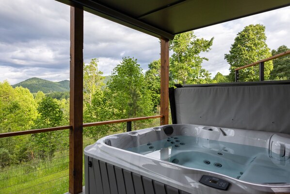 Soak under the stars or refresh in the afternoon breeze—this private hot tub is pure mountain luxury.